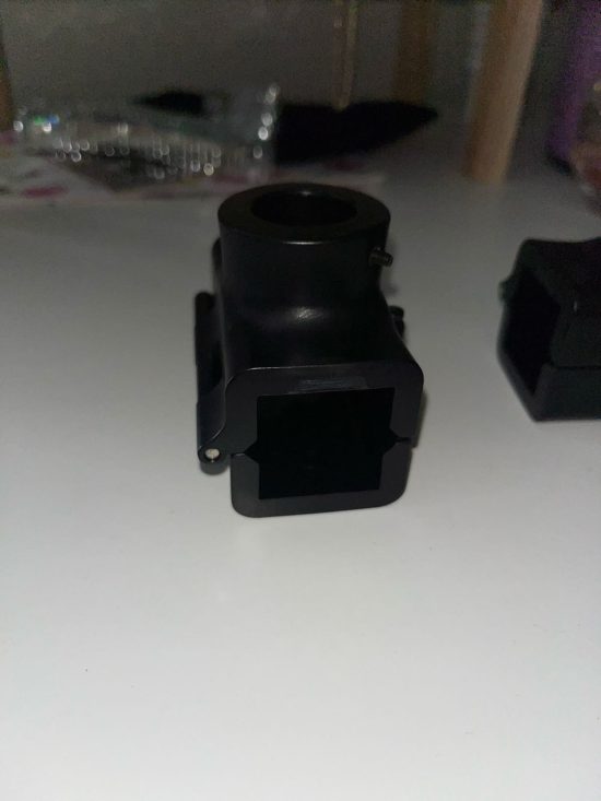 A black plastic object sitting on top of a table.